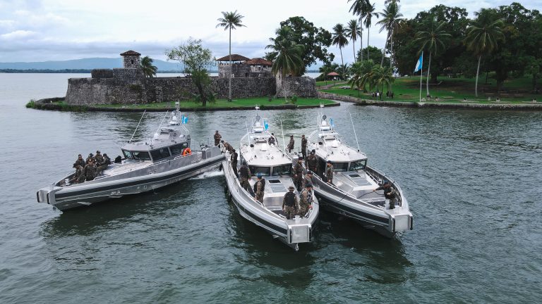 Navy Patron boats near a historic fort in Guatemala.